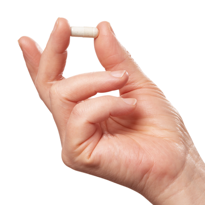Close-up of a hand holding a single off-white supplement capsule against a plain white background, for daily biotin and skin support