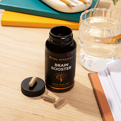 Green palm leaf beside two blank white cards on a white background.