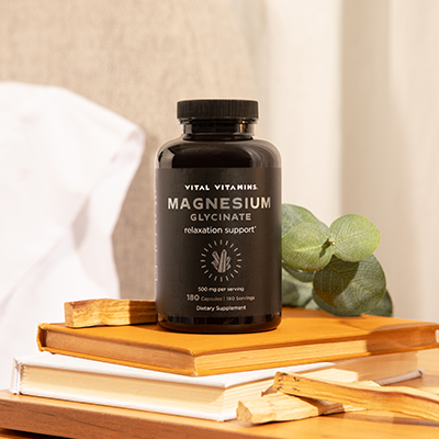 Green palm leaf beside two blank white cards on a white background.