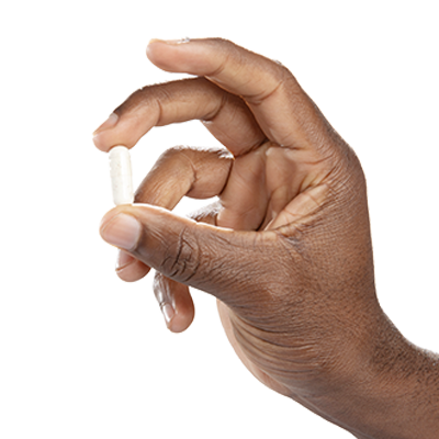 Hand holding a single Multi Collagen Complex capsule on a clean background - Vital Vitamins five-type collagen supplement
