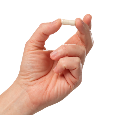 Hand holding a single white Probiotic Complex capsule on a clean background - Vital Vitamins 70 billion CFU probiotic supplement